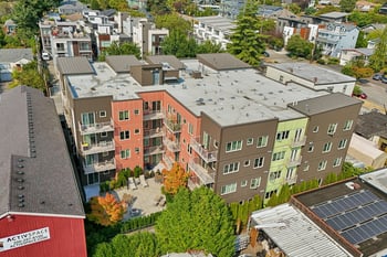 Aerial view of REV Fremont showing colorful modern exterior, balconies, and central courtyard patio.
