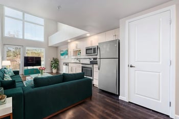 Ludwig Apartments Seattle living room with modern finishes and large window.