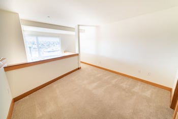 Union Bay Lofts apartment living room in Seattle, WA with large windows and hardwood floors.