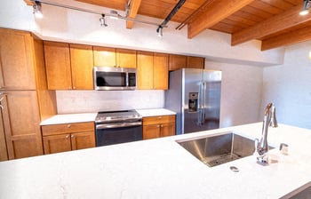 Union Bay Lofts rental living area in Seattle with large window and modern finishes.