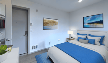 a bedroom with a bed and a door to a bathroom