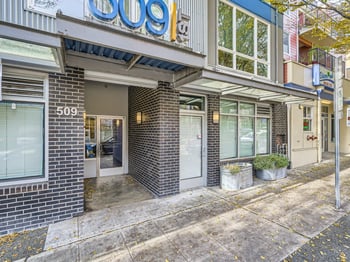 Spacious living room with large windows in rental apartment at 509 1st Ave, Seattle.