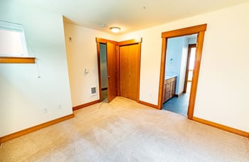 Union Bay Lofts Seattle apartment living room with large windows, hardwood floors, modern design, rental listing.