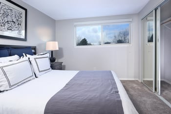 a bedroom with a large bed and a large window