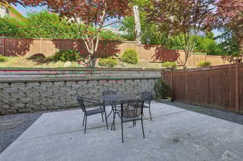 Bright living room in Champagne at Bellevue apartment, Bellevue, WA, with large windows and modern finishes.