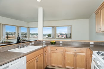 A kitchen with wooden cabinets and a stove top oven.