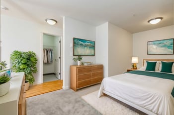 Bright living room at Gilbert House Apartments, Seattle, WA – open layout with large windows.