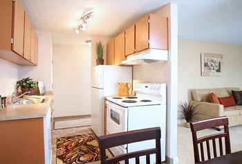 Bright living area at Hill Crest Apartments, Tukwila, WA, with large windows and neutral decor.