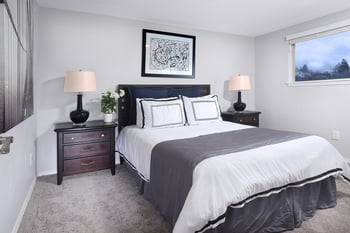 a bedroom with a bed and two night stands with lamps