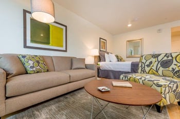 Bright living room at Lillehammer Apartments, Seattle, WA; modern finishes, large windows, available for rent.
