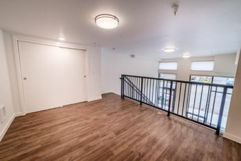 Open concept living area with hardwood floors and a balcony view