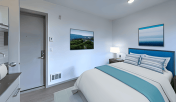 a bedroom with a bed and a door to a bathroom