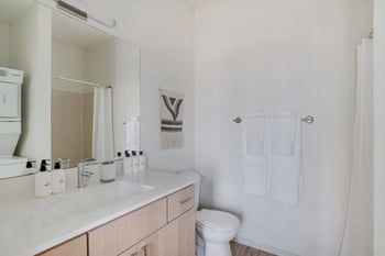 Bright living room in a Werner Seattle apartment with an open layout and modern kitchen.