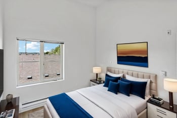 a bedroom with a bed and a window