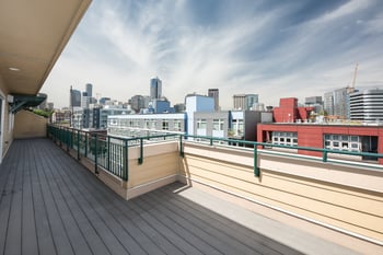 A balcony with a view of a city skyline.