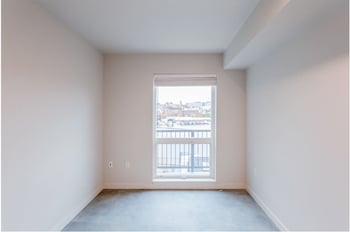 Robins Nest apartment living area in Seattle, WA featuring bright natural light and modern finishes.