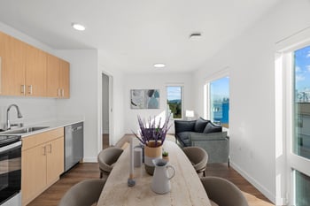 a kitchen and living room with a table and chairs
