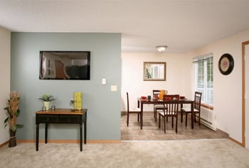 Bright 2-bedroom apartment living area with stainless steel appliances at The Park at Fife, Fife, WA.