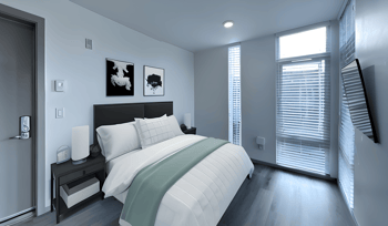 a bedroom with a bed and a window