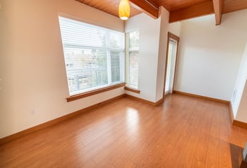 Union Bay Lofts Seattle apartment living space with modern finishes, hardwood floors, and large windows.