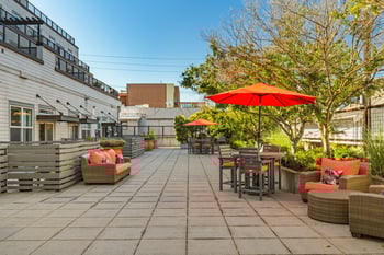 Living room at Gilbert House Apartments, Seattle, WA — bright with large windows and modern decor.
