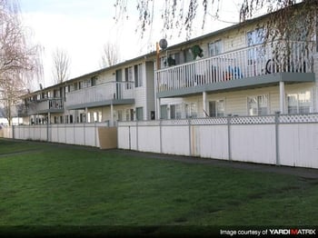 Bright living room in The Park at Fife rental apartment, Fife, WA, open-concept layout with large windows.