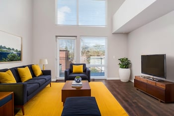 Ludwig Apartments Seattle living room interior with modern furniture and large windows—rental unit photo.