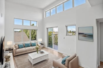 a living room with a couch and a coffee table and sliding glass doors