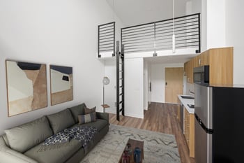 A modern living room with a grey couch and a wooden cabinet.