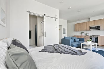 Spacious living area in Werner apartment for rent, Seattle, WA; neutral decor, wood floors, natural light.