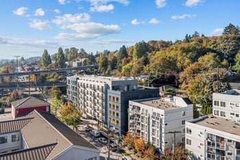 Aerial view of modern apartment buildings and city streets at Harbor Flats in Seattle, with a hig...