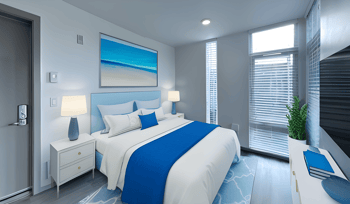 a blue and white bedroom with a bed and a window