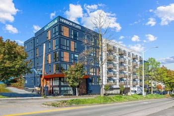 a large blue building with a street in front of it