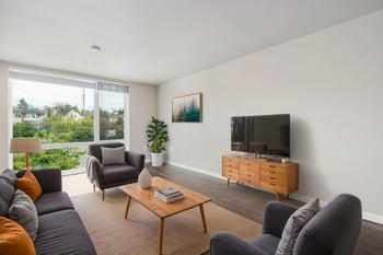 Bright living room at Ludwig Apartments in Seattle, WA with modern furnishings and large windows.