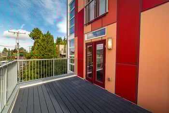 Bright living room at Wallingford Studios in Seattle, modern apartment with large windows and neutral decor.