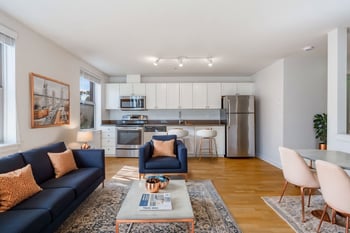 Interior living room at Gilbert House Apartments, Seattle, WA – bright accessible space with large windows and modern finishe