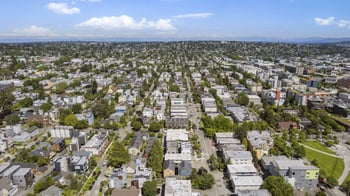 an aerial view of a city with houses and trees