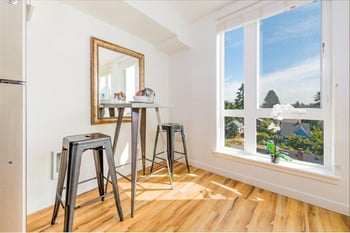 Lillehammer Apartments living room in Seattle, WA; bright, modern rental with sofa, coffee table, and decor.