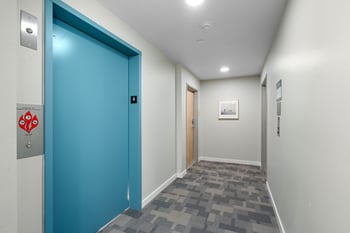 a blue door in a hallway of a building