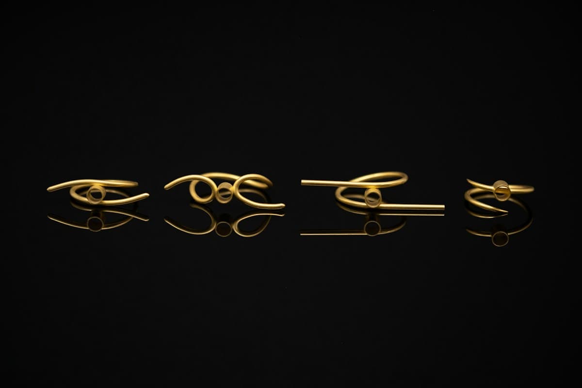 Cuatro anillos finos en oro sobre fondo negro