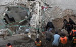 Security personnel and residents rescue injured blast victims from derailed train carriages after a suicide car bomb attack in Quetta, Balochistan