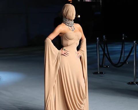 Kim Kardashian wearing a full-body Maison Margiela gown with a face mask at the 2025 Academy Museum Gala