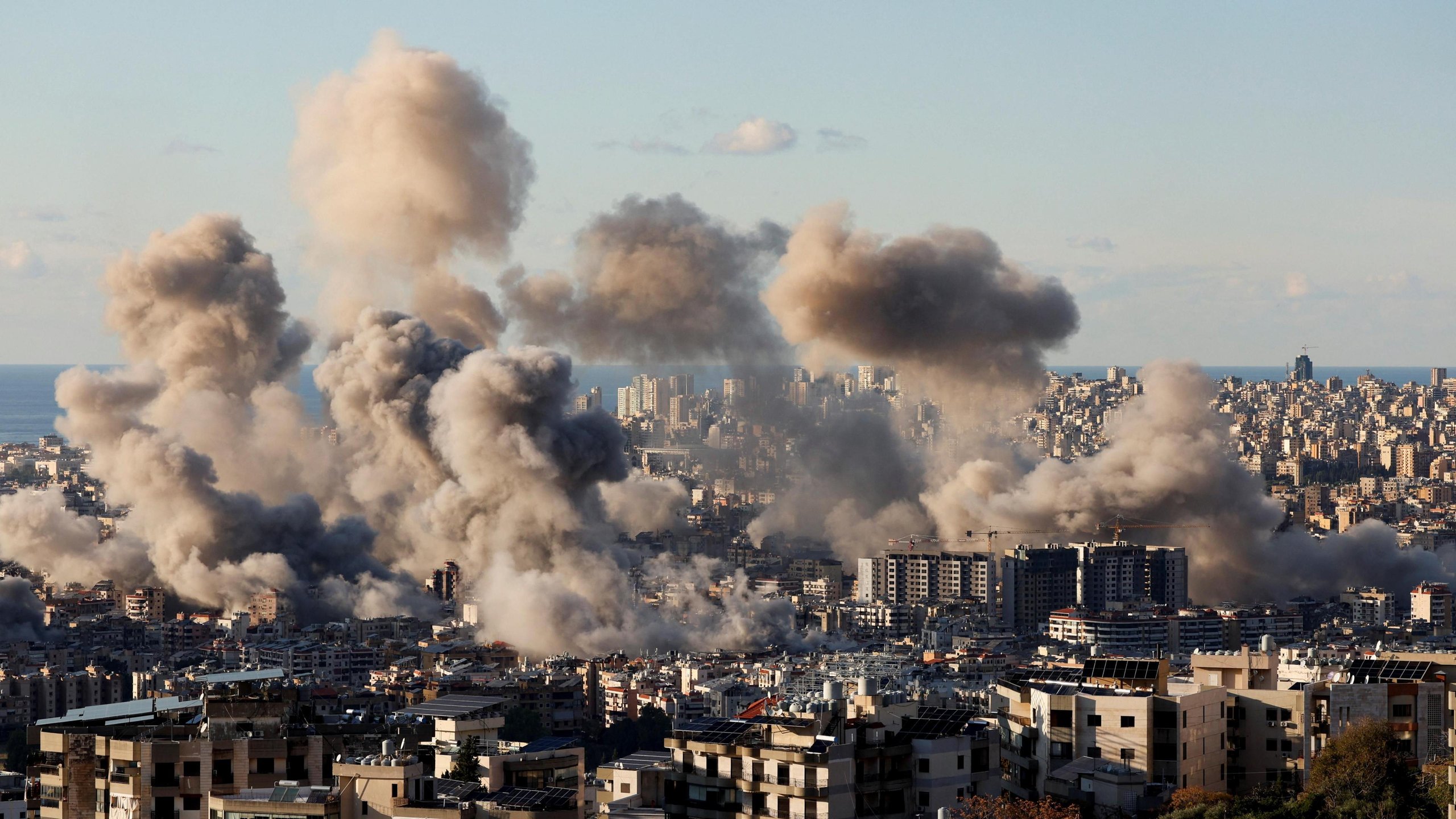 Gaza city skyline with smoke rising amid Israeli airstrikes in 2025
