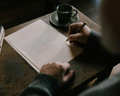 A writer sits at a quiet desk practicing mindfulness to improve focus and overcome creative anxiety while writing