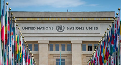 UN Security Council building with veto symbol highlighting global paralysis