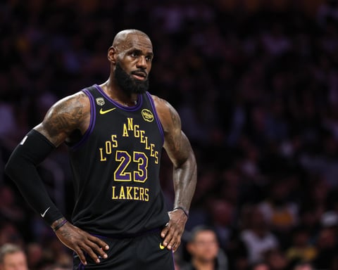 LeBron James in Los Angeles Lakers jersey during NBA playoff game with uncertain expression about retirement decision