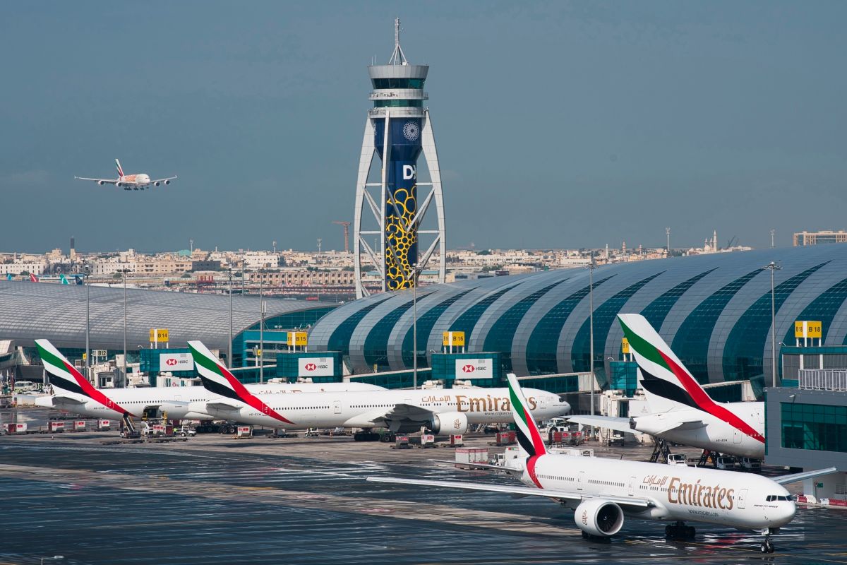 An Emirates aircraft lands at Dubai airport as Gulf carriers face losses from higher jet fuel costs in 2026