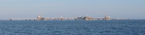 An LNG terminal with storage tanks, illustrating a liquefied natural gas story