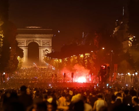 PSG fans gather on the Champs-Elysees in Paris after Champions League win over Arsenal in Budapest