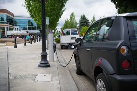 A UK electric vehicle charging station as battery EV annual sales outpace petrol for the first time